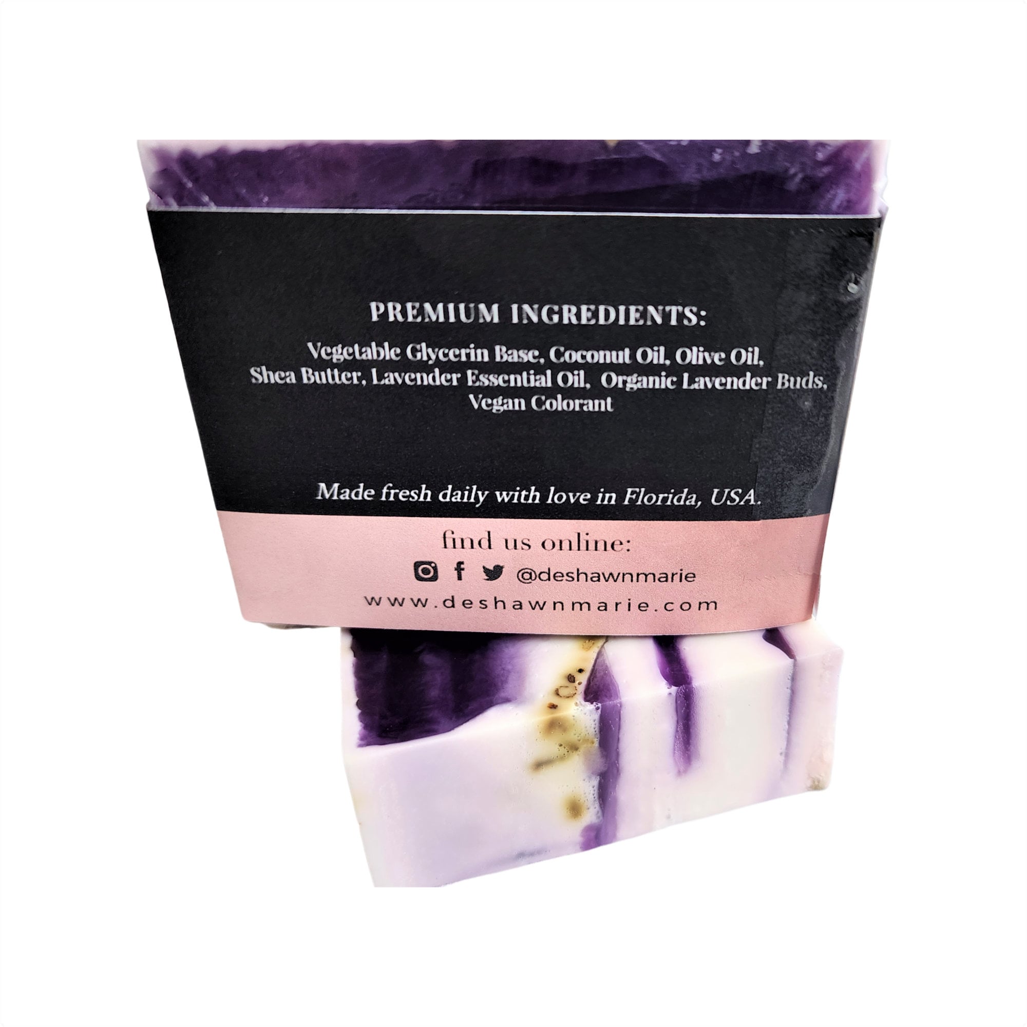 A beautifully crafted bar of French Lavender Soap with dried lavender flowers embedded, showcasing its rich purple hue and artisanal quality.