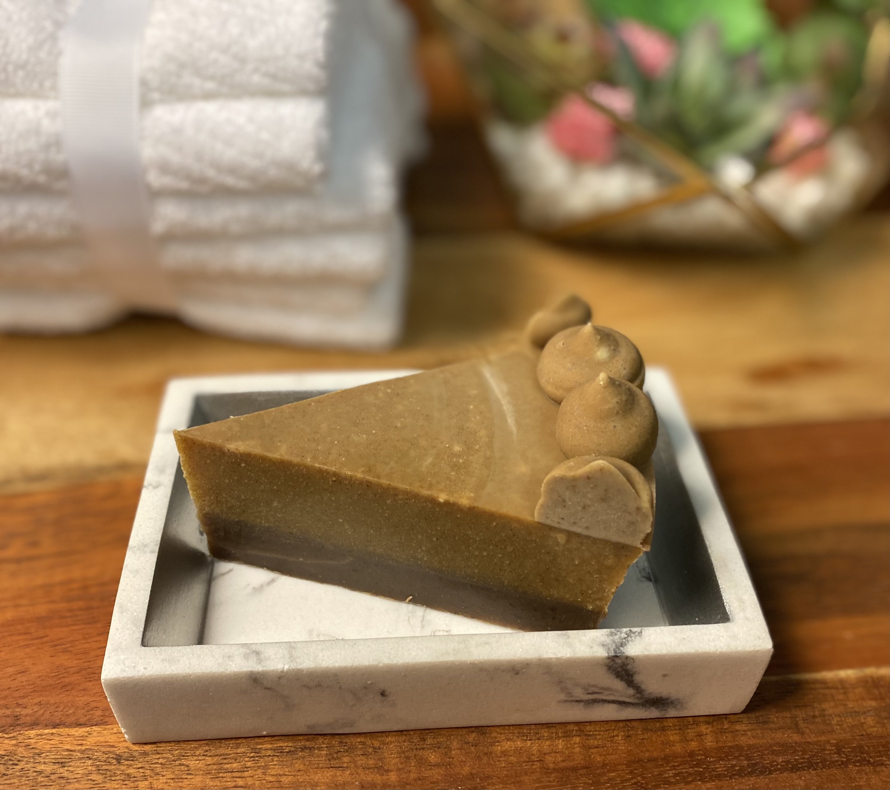 A slice of Goats Milk Pumpkin Soap with a creamy texture, colored with turmeric powder and scented with pumpkin fragrance oils.