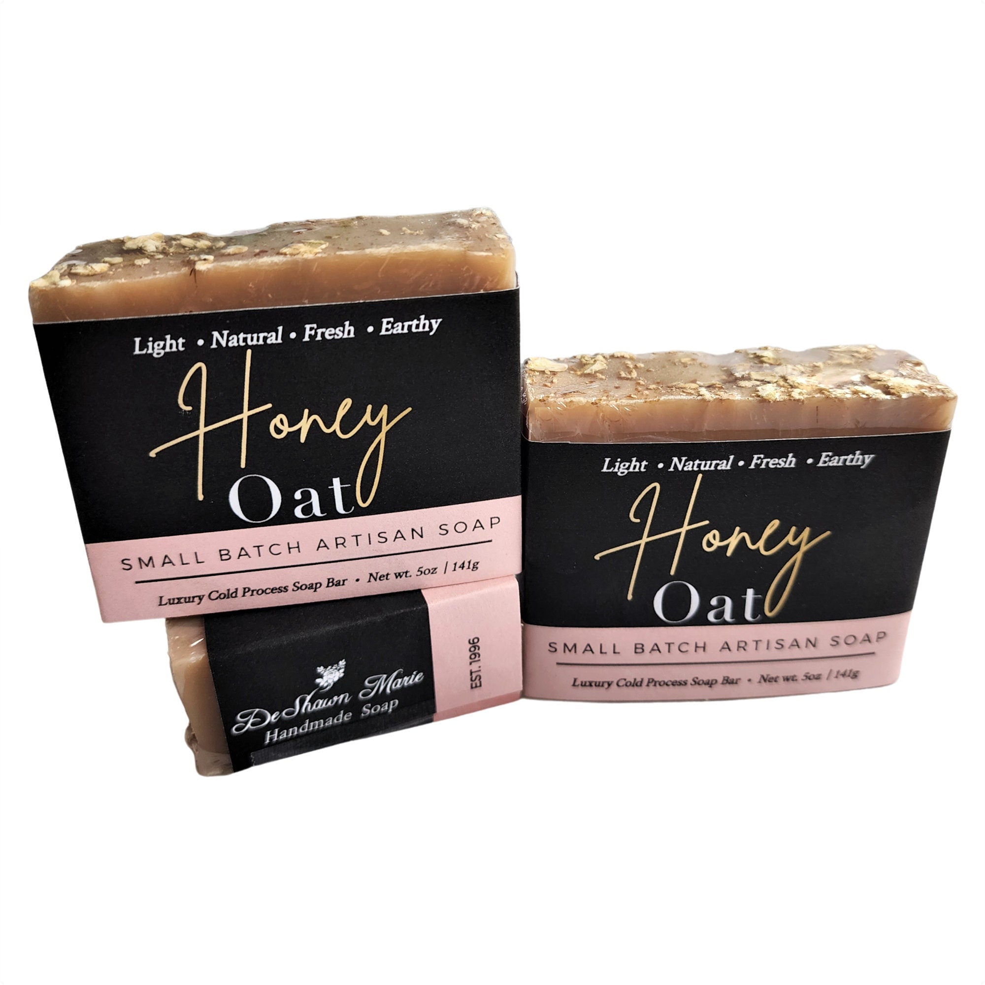 A rustic Honey Oat Soap bar featuring a light honey color and visible oat flakes, wrapped in eco-friendly packaging.