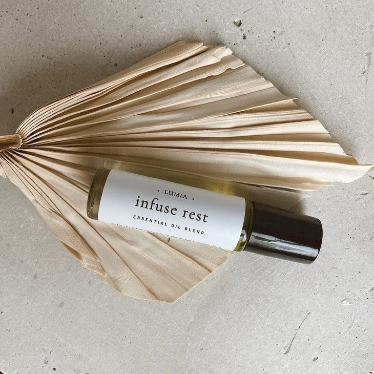 Infuse Rest roll-on bottle featuring calming essential oils for relaxation and sleep.