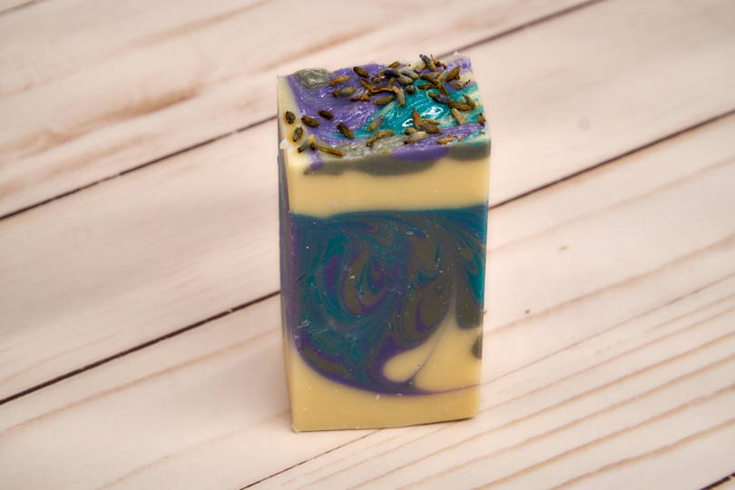 Lavender Martini Soap bar with lavender buds and citrus notes, showcasing its handcrafted quality and elegant design.