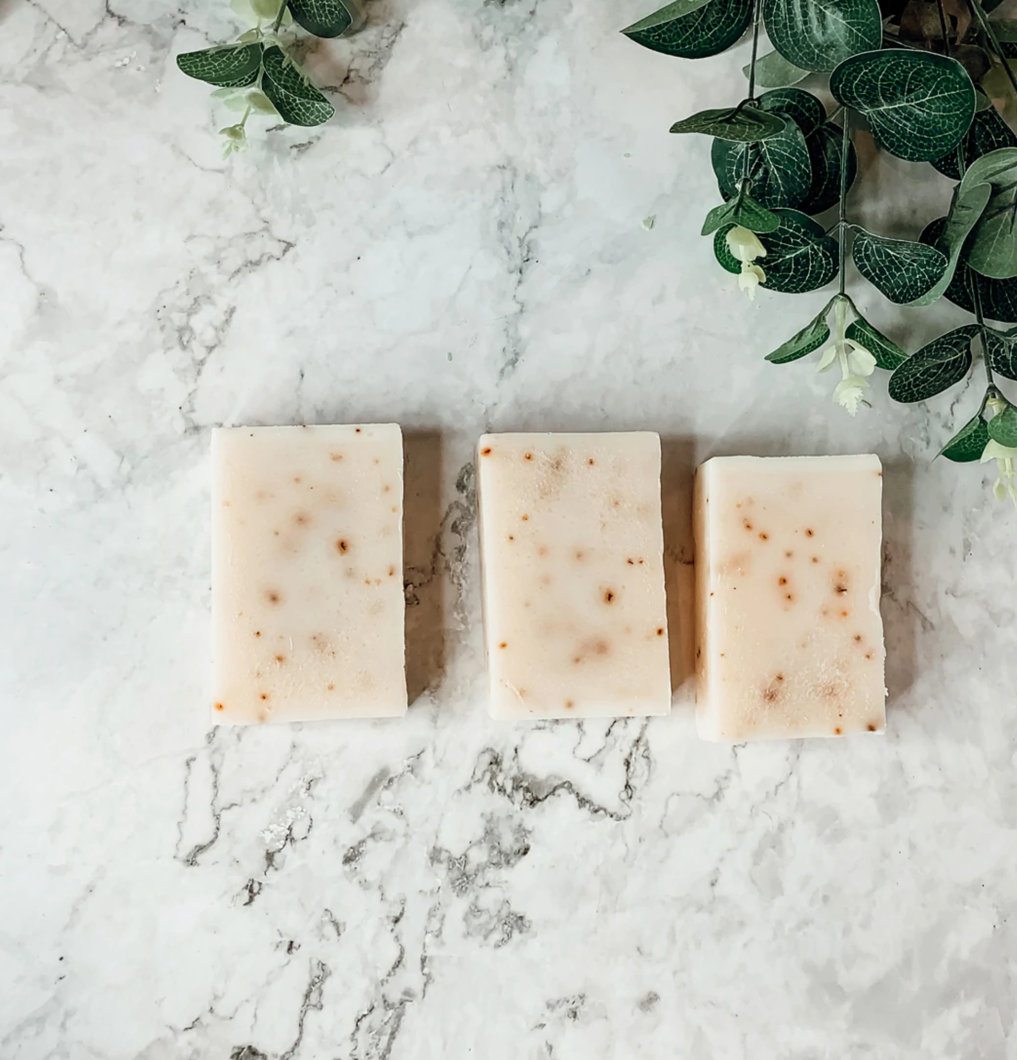 Lavender + Patchouli soap bar with real lavender buds, showcasing its handcrafted design and natural colors.