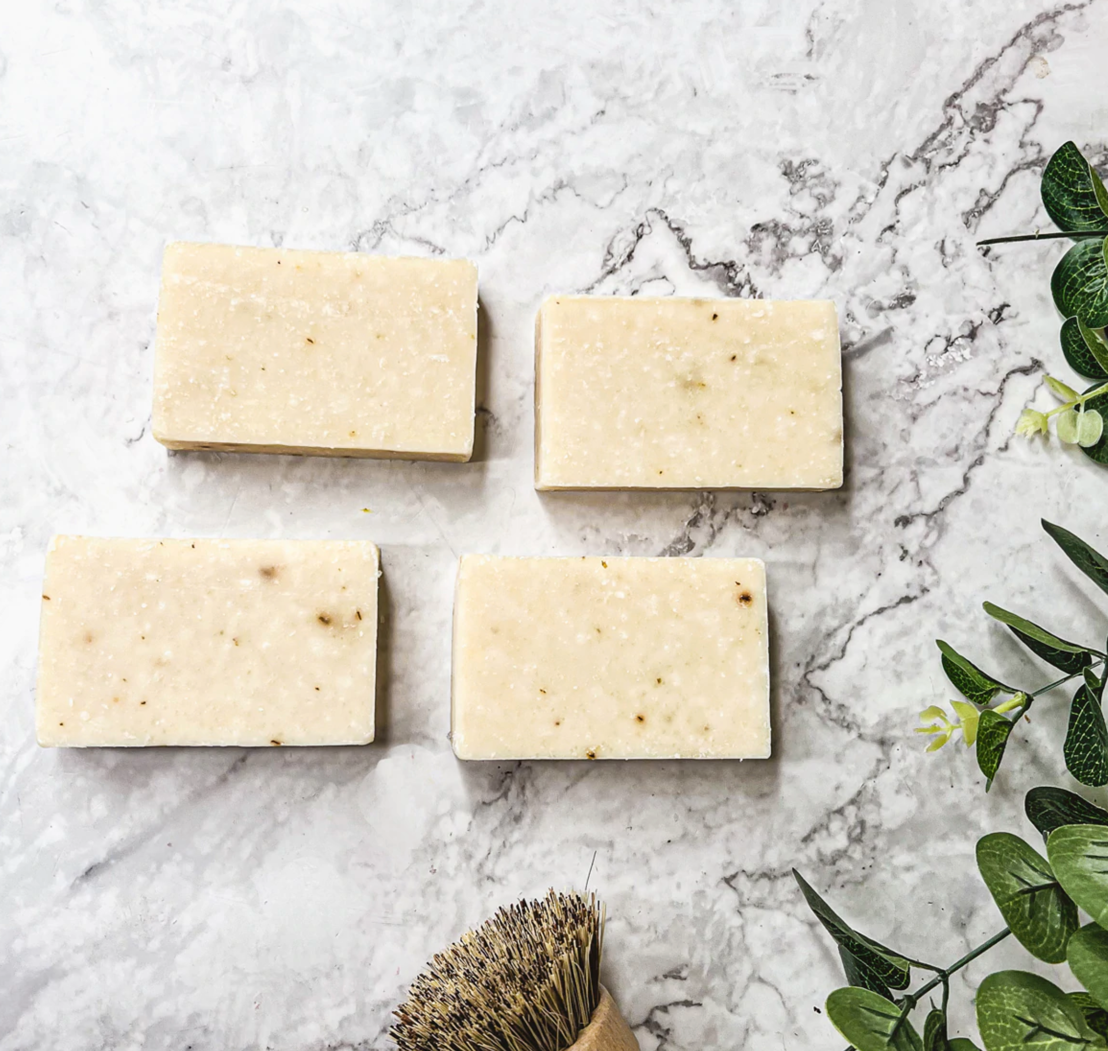 Lavender + Patchouli soap bar with real lavender buds, showcasing its handcrafted design and natural colors.