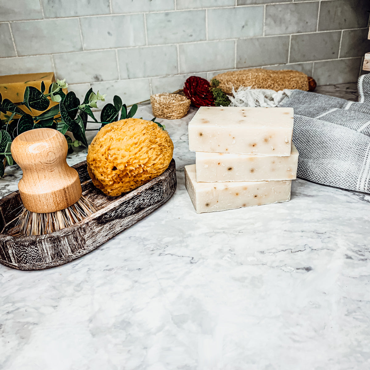 Lavender + Patchouli soap bar with real lavender buds, showcasing its handcrafted design and natural colors.