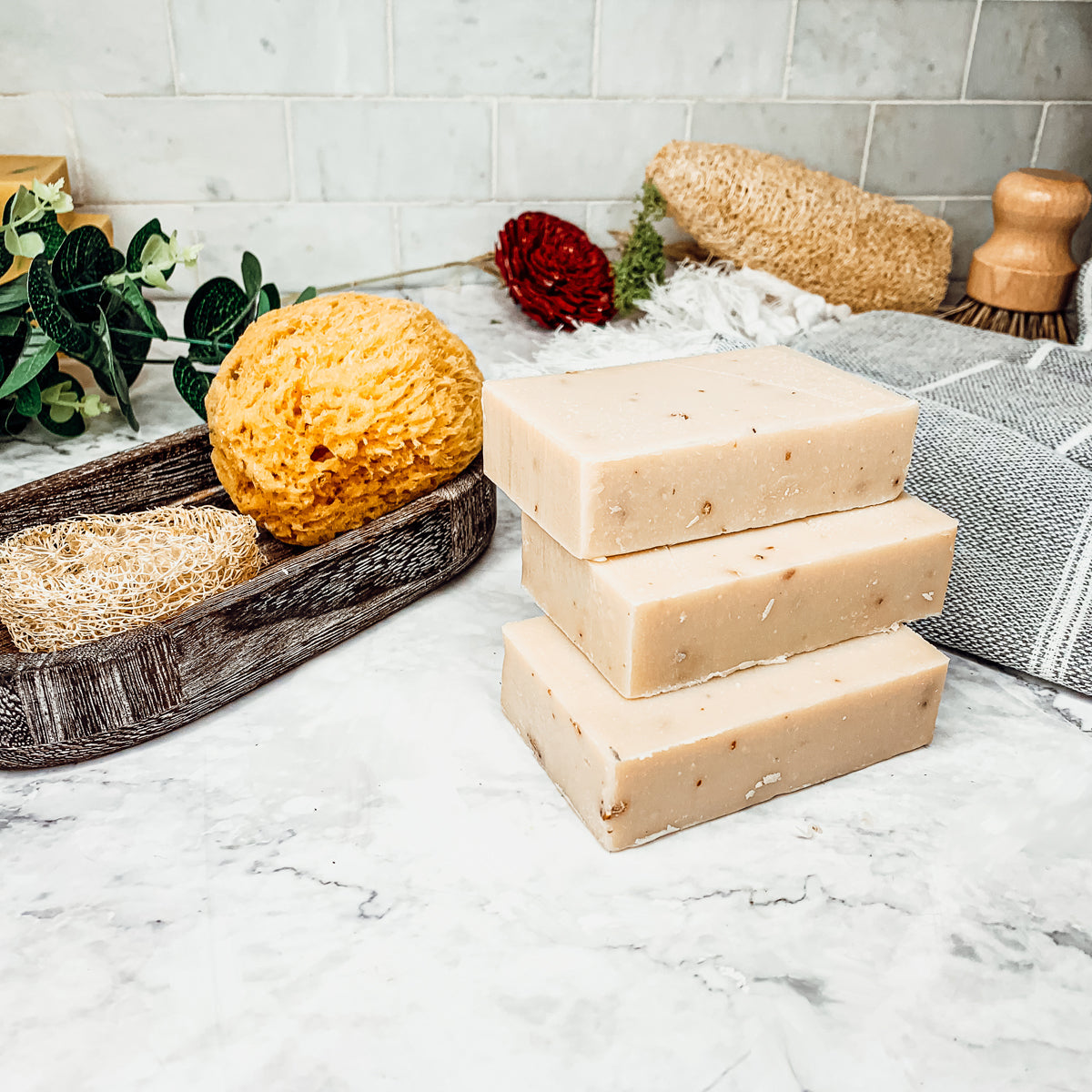 Lavender + Patchouli soap bar with real lavender buds, showcasing its handcrafted design and natural colors.