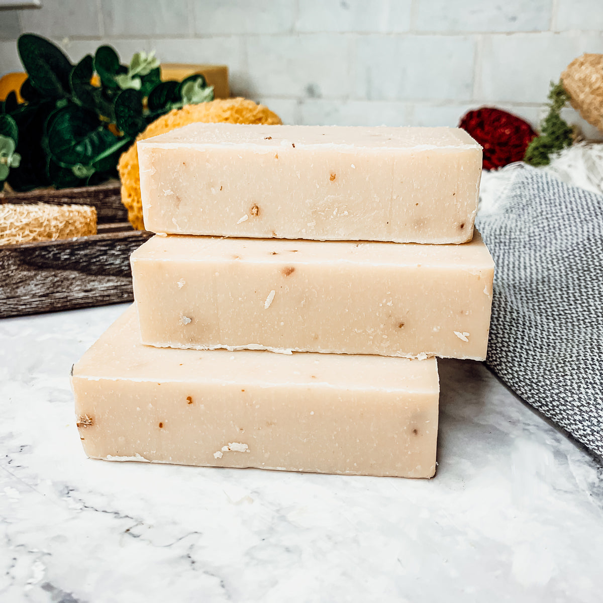 Lavender + Patchouli soap bar with real lavender buds, showcasing its handcrafted design and natural colors.