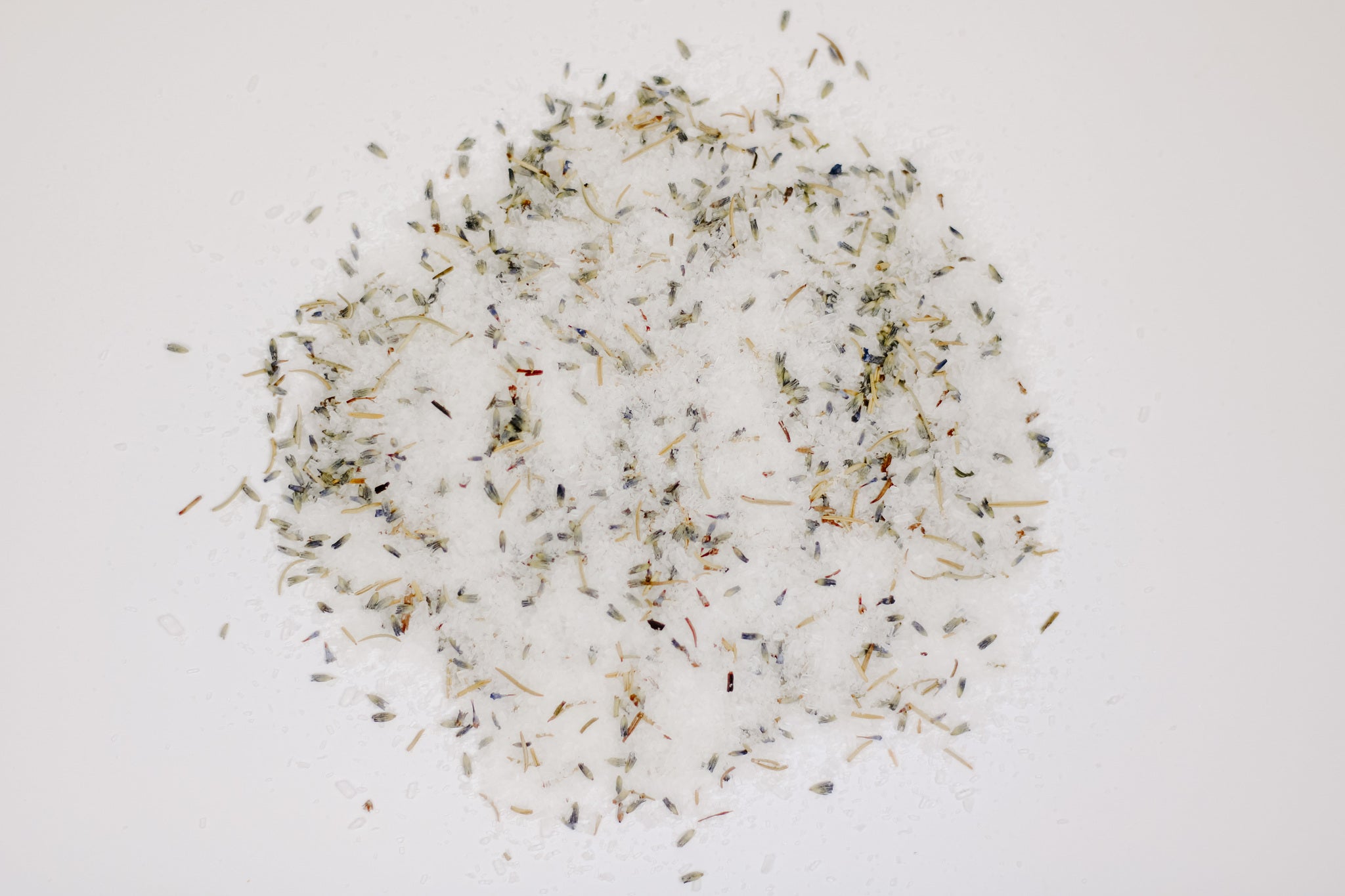 A resealable kraft pouch filled with Lavender + Rosemary Bath Salt, showcasing dried lavender buds and rosemary leaves.