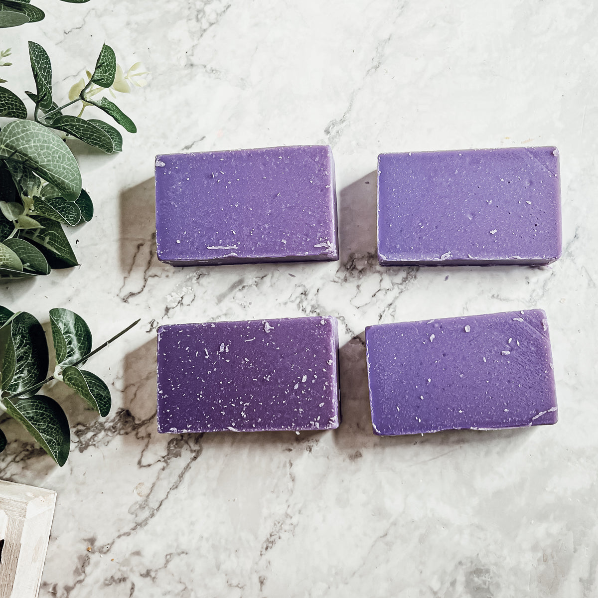 A bar of Lilac Love soap showcasing its beautiful lilac color and floral design, handcrafted with organic ingredients.