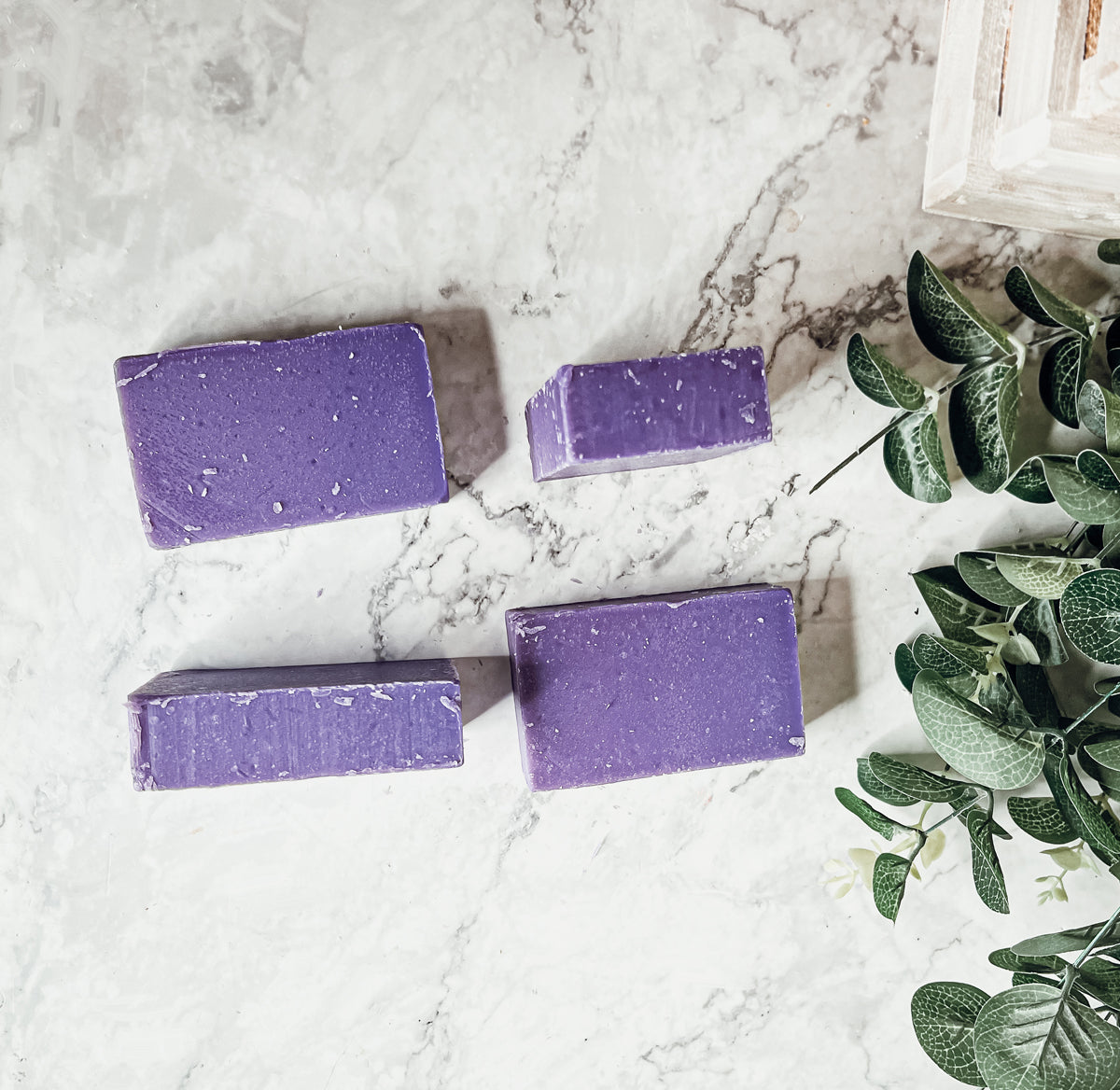 A bar of Lilac Love soap showcasing its beautiful lilac color and floral design, handcrafted with organic ingredients.