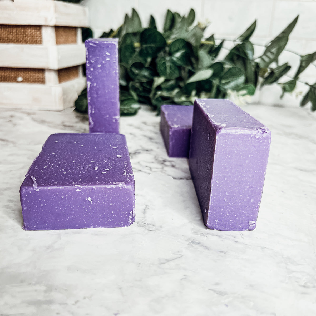 A bar of Lilac Love soap showcasing its beautiful lilac color and floral design, handcrafted with organic ingredients.