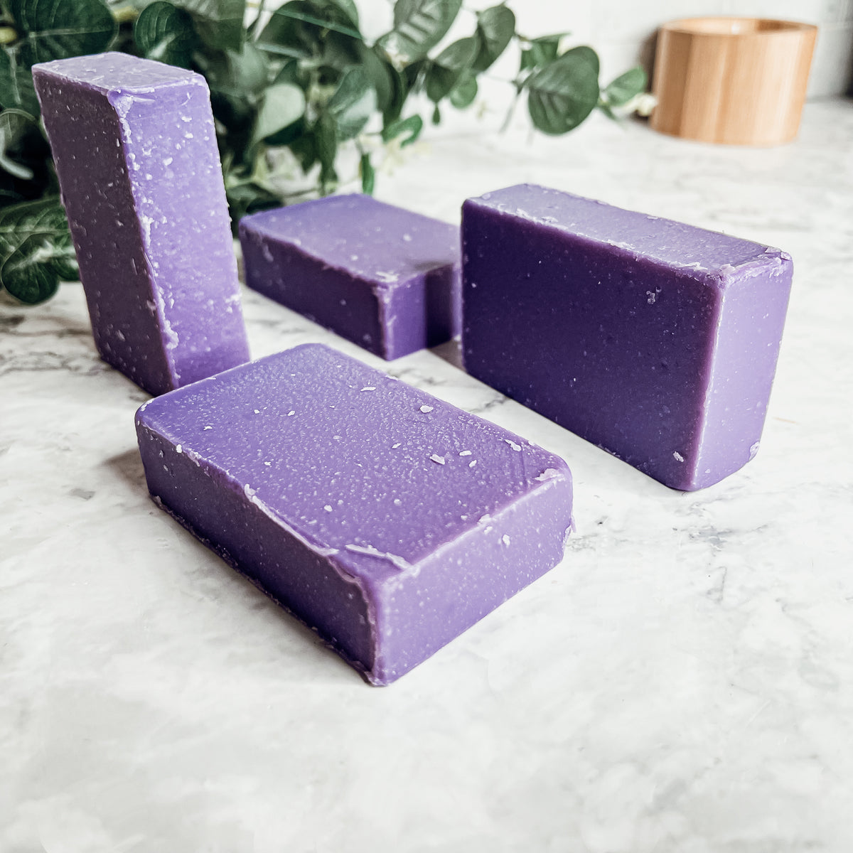 A bar of Lilac Love soap showcasing its beautiful lilac color and floral design, handcrafted with organic ingredients.