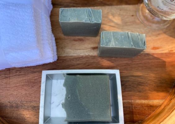 Men's Clay & Shea Butter Soap bar with a creamy texture, showcasing its natural ingredients and rich color.