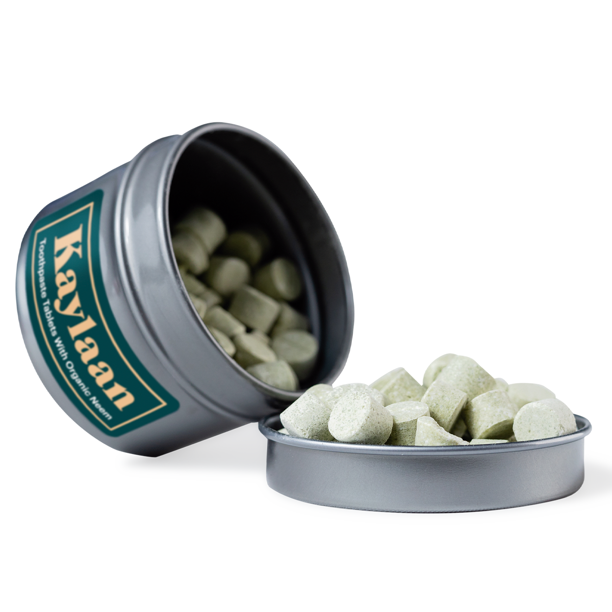 A close-up of Neem Toothpaste Tablets in a small container, showcasing their natural, organic appearance.