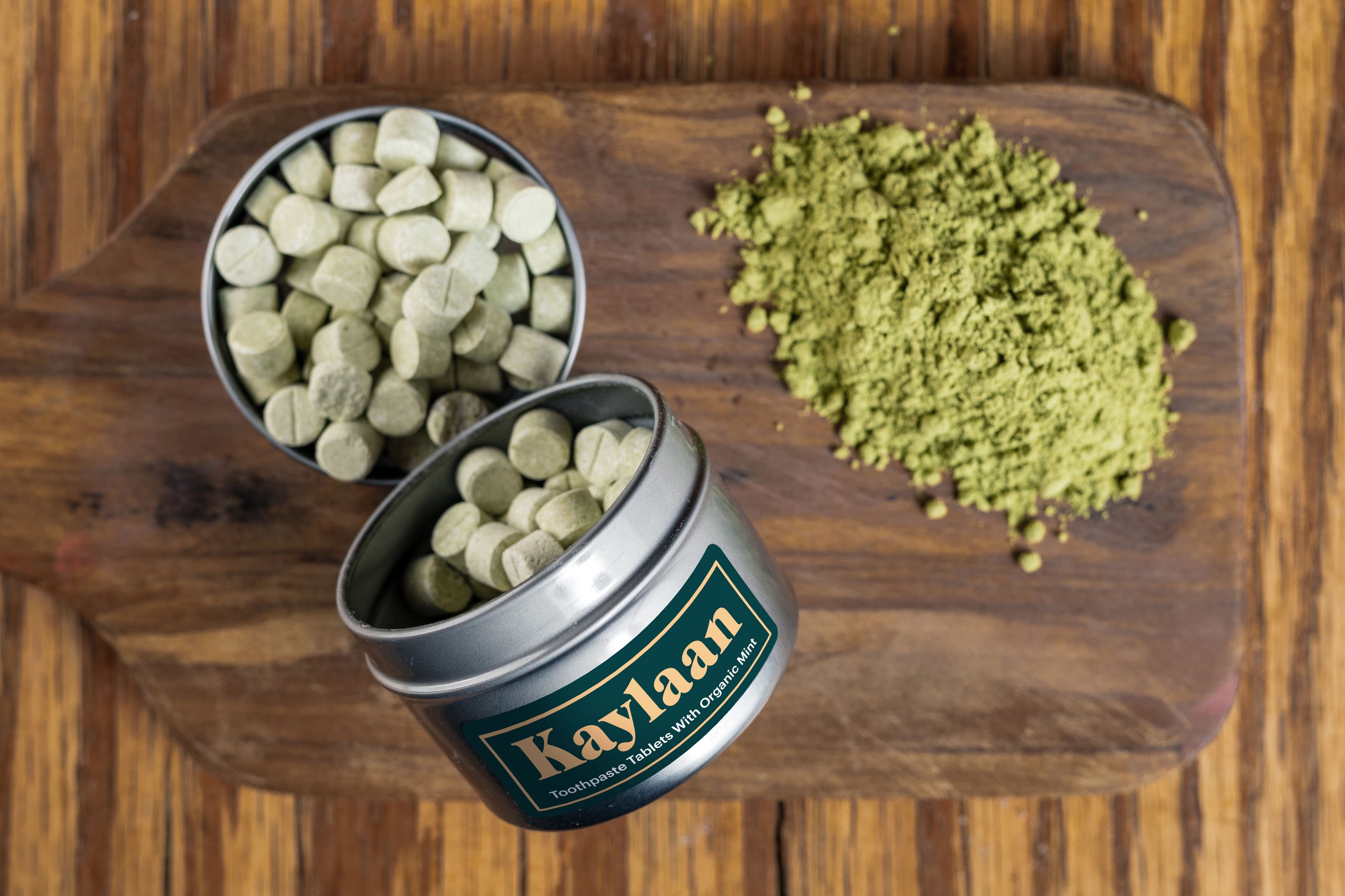 A close-up of Neem Toothpaste Tablets in a small container, showcasing their natural, organic appearance.