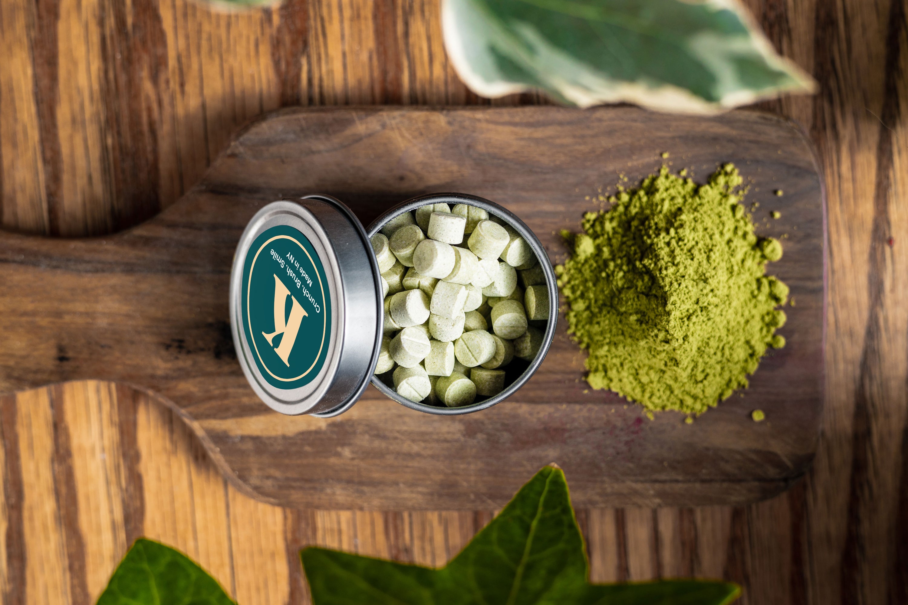 A close-up of Neem Toothpaste Tablets in a small container, showcasing their natural, organic appearance.