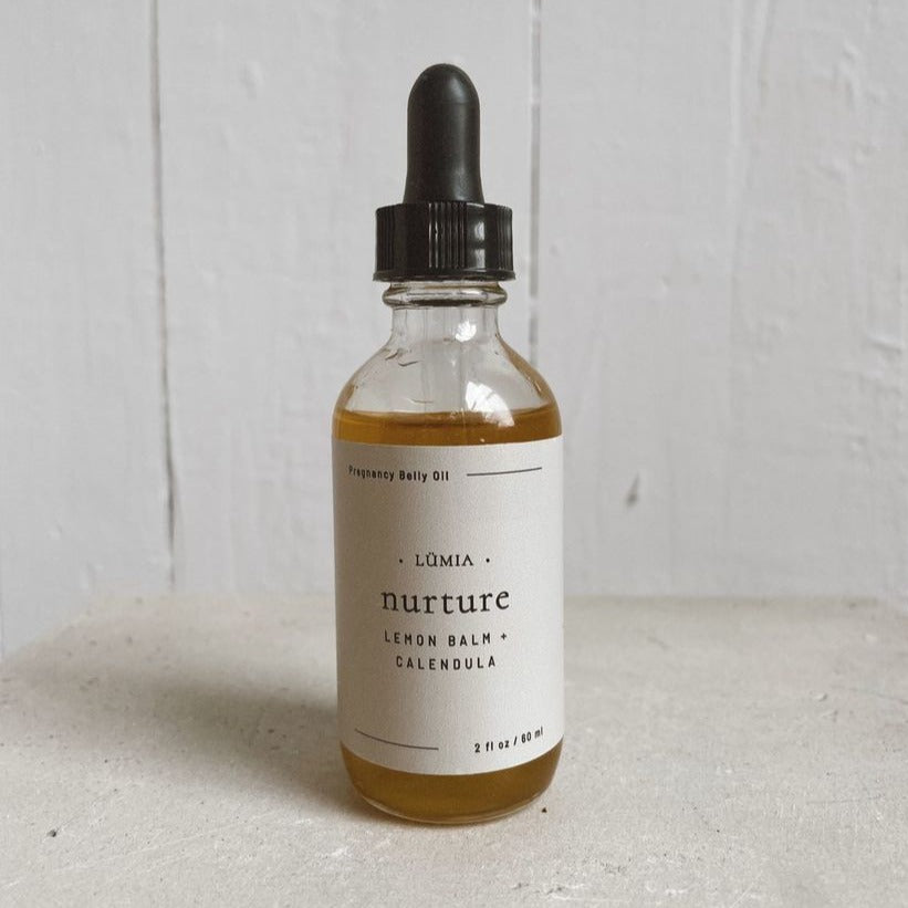 Nurture Pregnancy Belly Oil bottle with herbal ingredients, designed for new and expecting mothers.