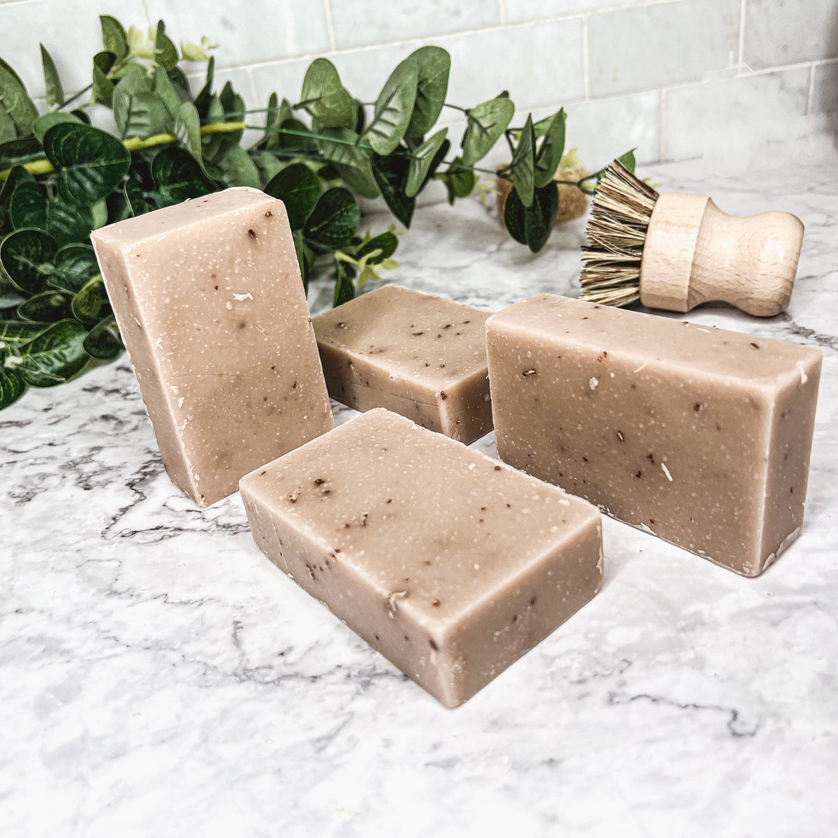 A bar of Oatmeal Milk & Honey soap with a creamy texture, featuring visible ground oatmeal particles and a light, natural color.