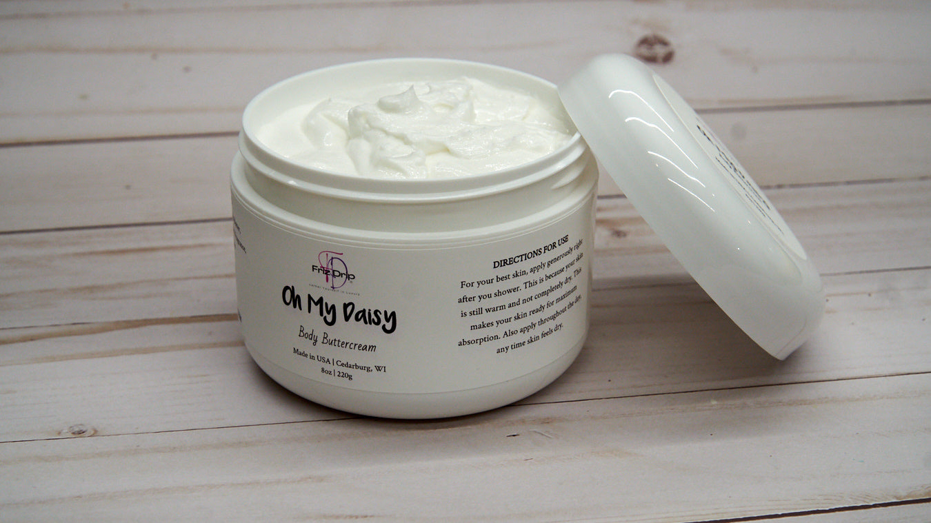 Oh My Daisy Body Cream in an elegant jar, showcasing its creamy texture and floral design.