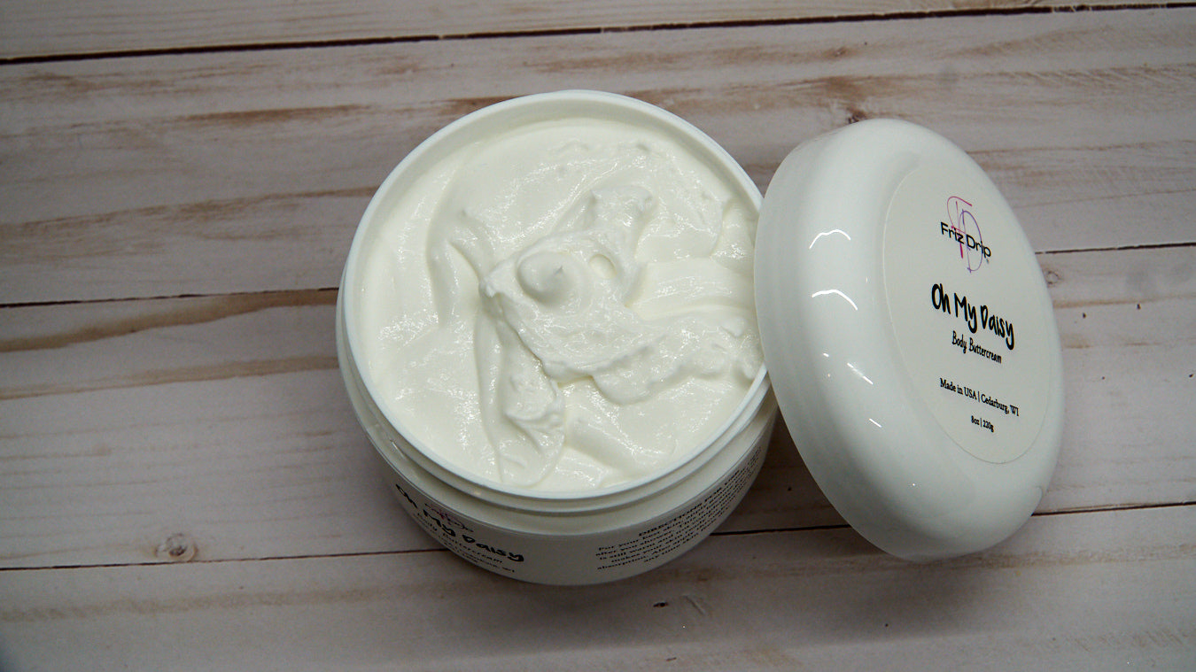 Oh My Daisy Body Cream in an elegant jar, showcasing its creamy texture and floral design.