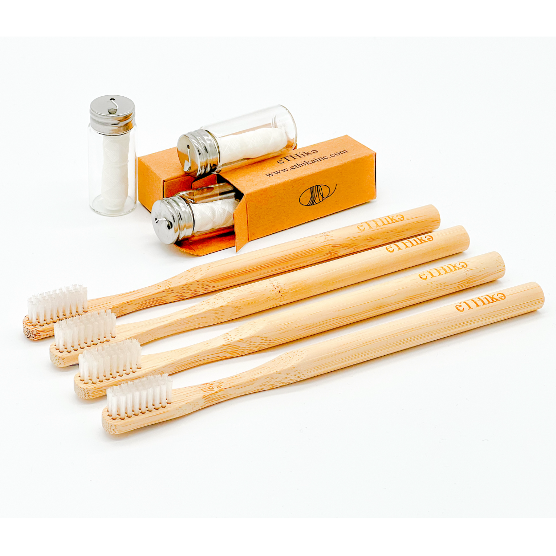 A complete Oral Hygiene Kit featuring four bamboo toothbrushes and three mint dental flosses in a glass jar, all 100% natural and eco-friendly.