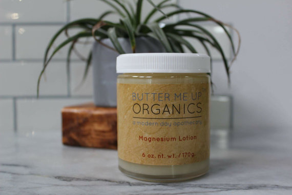 A glass jar of Organic Magnesium Lotion with a metal lid, showcasing its creamy texture and natural ingredients, ideal for skin hydration and relaxation.