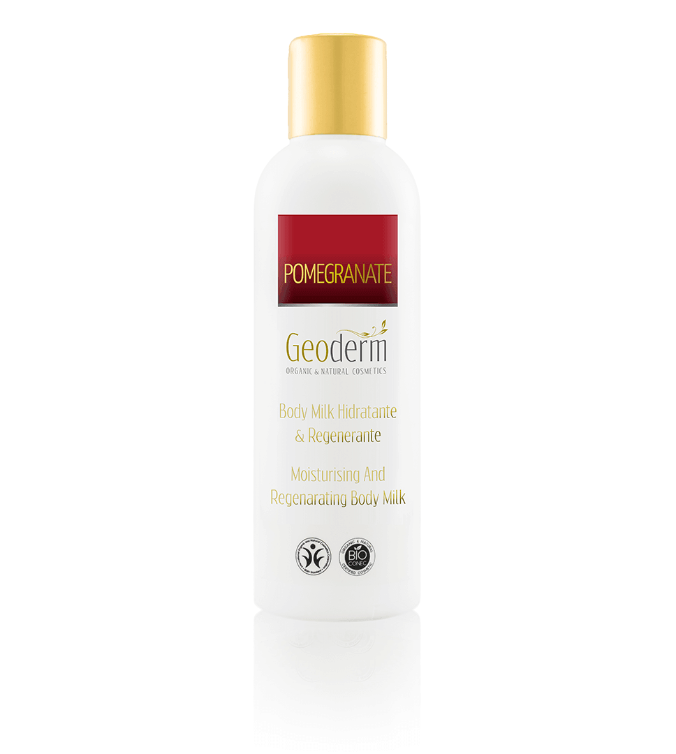 A bottle of Organic & Natural Pomegranate Body Milk, showcasing its elegant design and vibrant label, surrounded by pomegranate seeds and leaves.