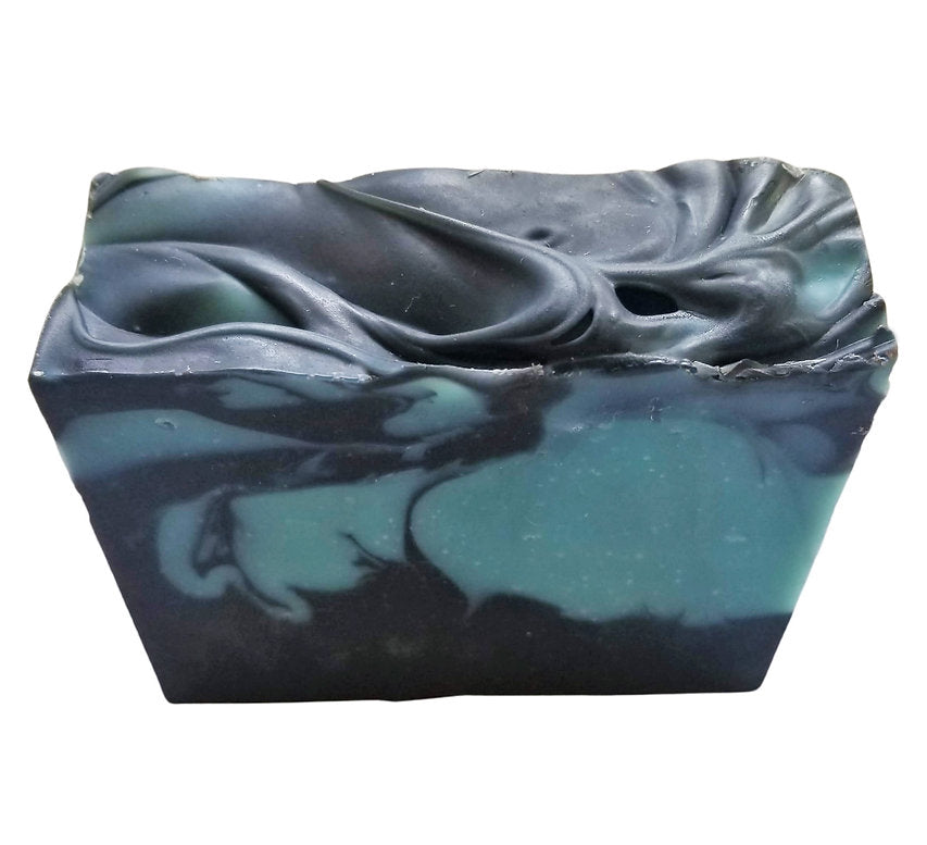 Patchouli Mint Soap bar with blue clay and activated charcoal, showcasing its rich texture and natural ingredients.