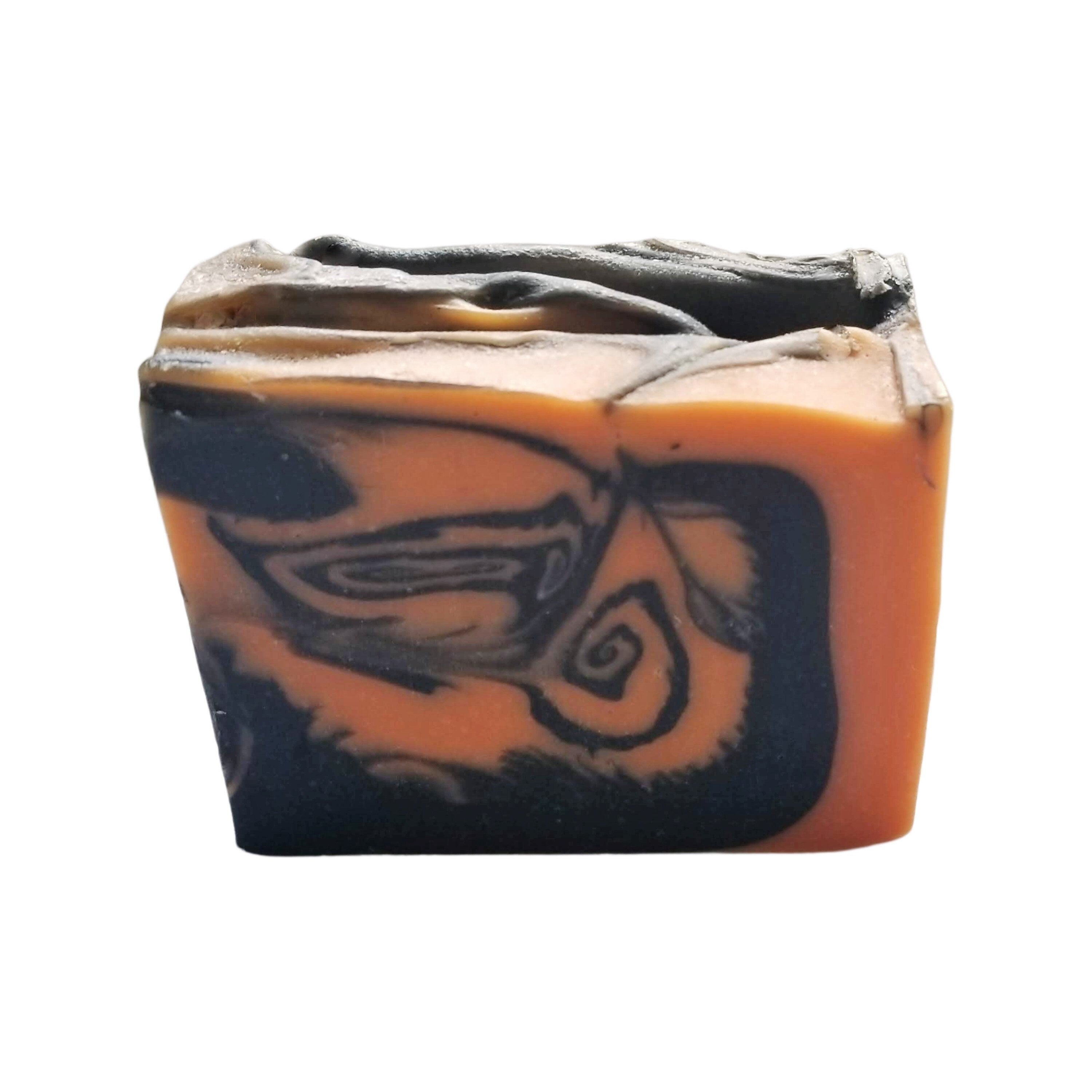 A beautifully crafted Patchouli Orange Soap bar, showcasing its earthy brown and vibrant orange colors, wrapped elegantly for a luxurious touch.