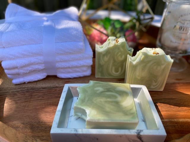 A beautifully swirled peppermint soap bar with vibrant colors, showcasing its creamy texture and natural ingredients.