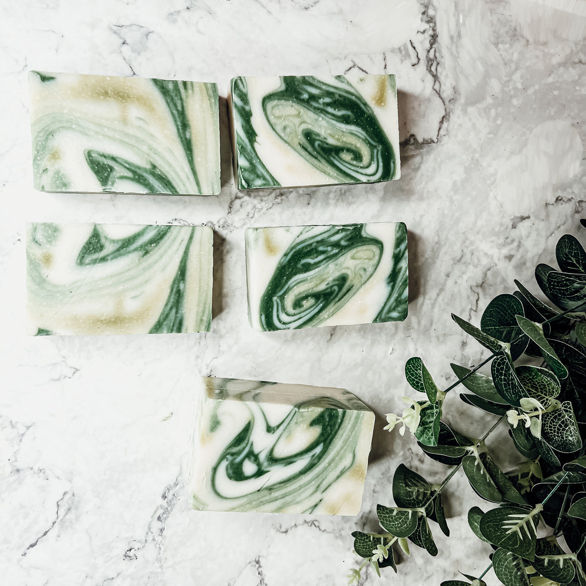 A bar of Peppermint + White Tea soap showcasing its unique design and vibrant colors, emphasizing its refreshing and natural ingredients.