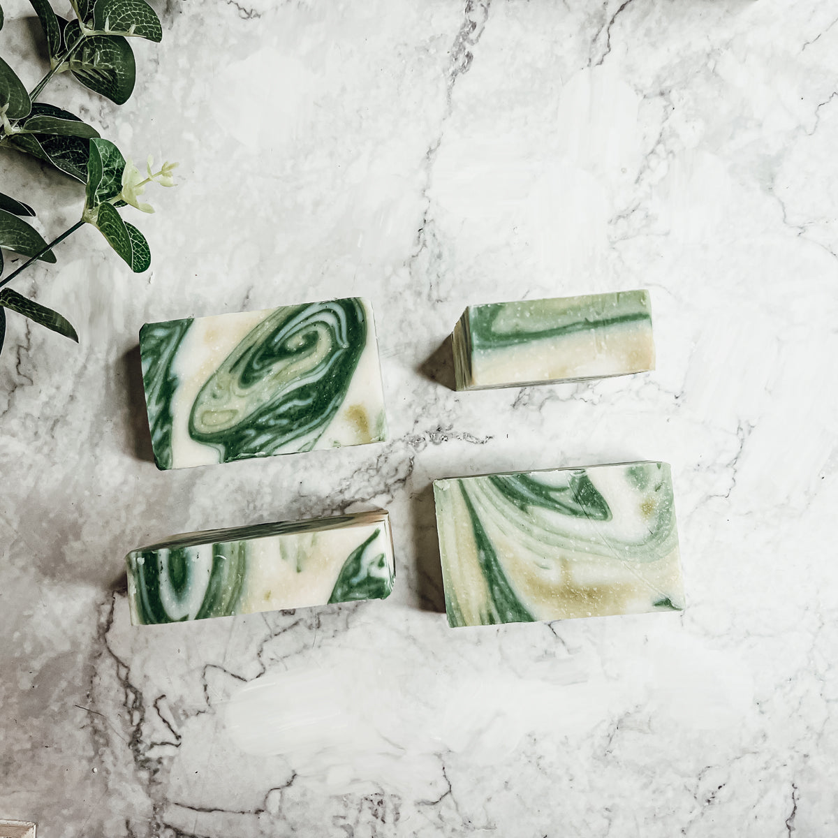 A bar of Peppermint + White Tea soap showcasing its unique design and vibrant colors, emphasizing its refreshing and natural ingredients.