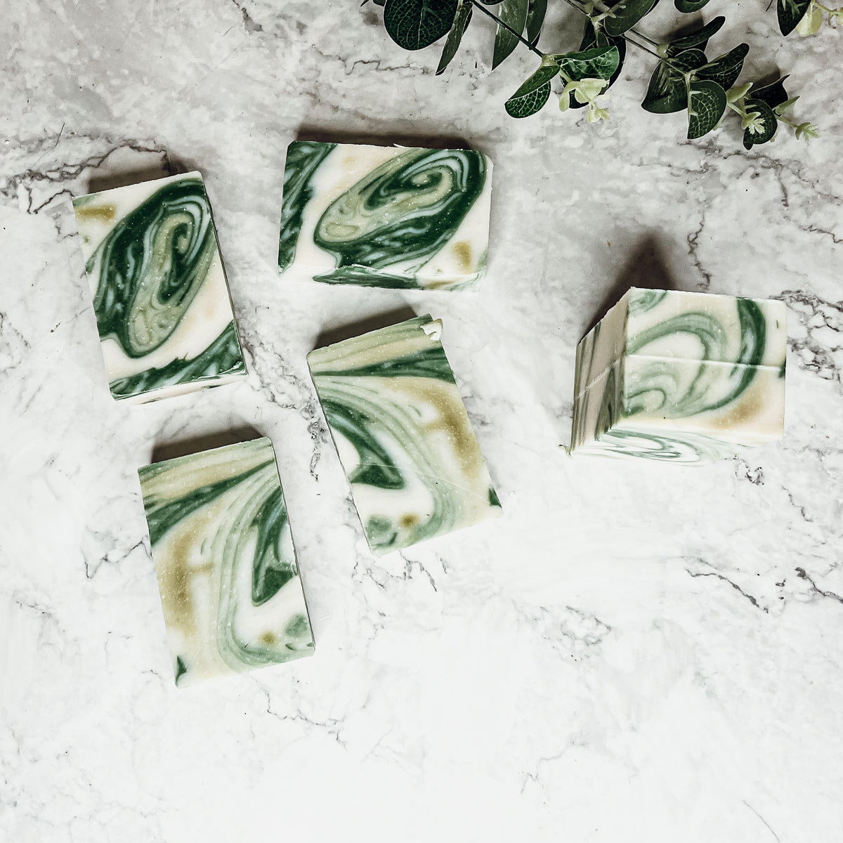 A bar of Peppermint + White Tea soap showcasing its unique design and vibrant colors, emphasizing its refreshing and natural ingredients.