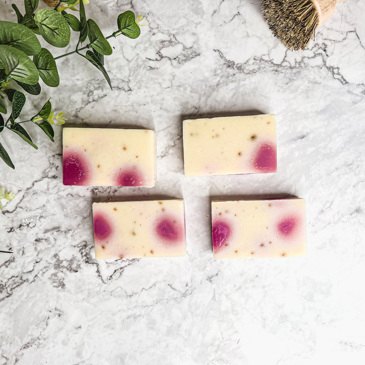 A beautifully handcrafted soap bar named Petal Dance, featuring real rose petals and a vibrant design, showcasing its organic ingredients.