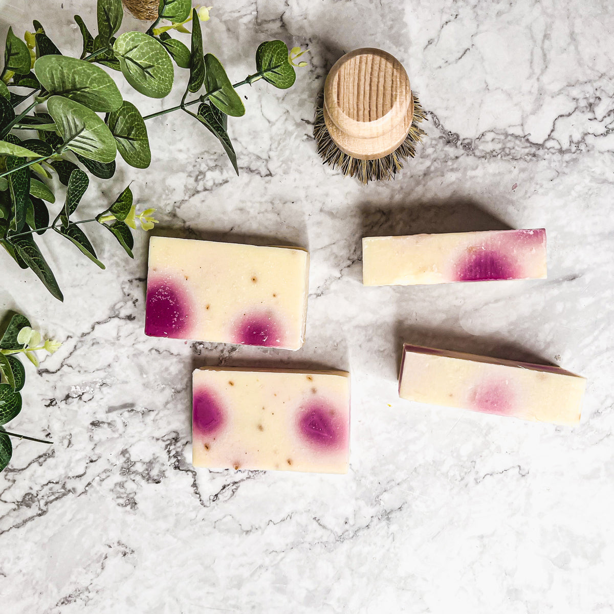 A beautifully handcrafted soap bar named Petal Dance, featuring real rose petals and a vibrant design, showcasing its organic ingredients.