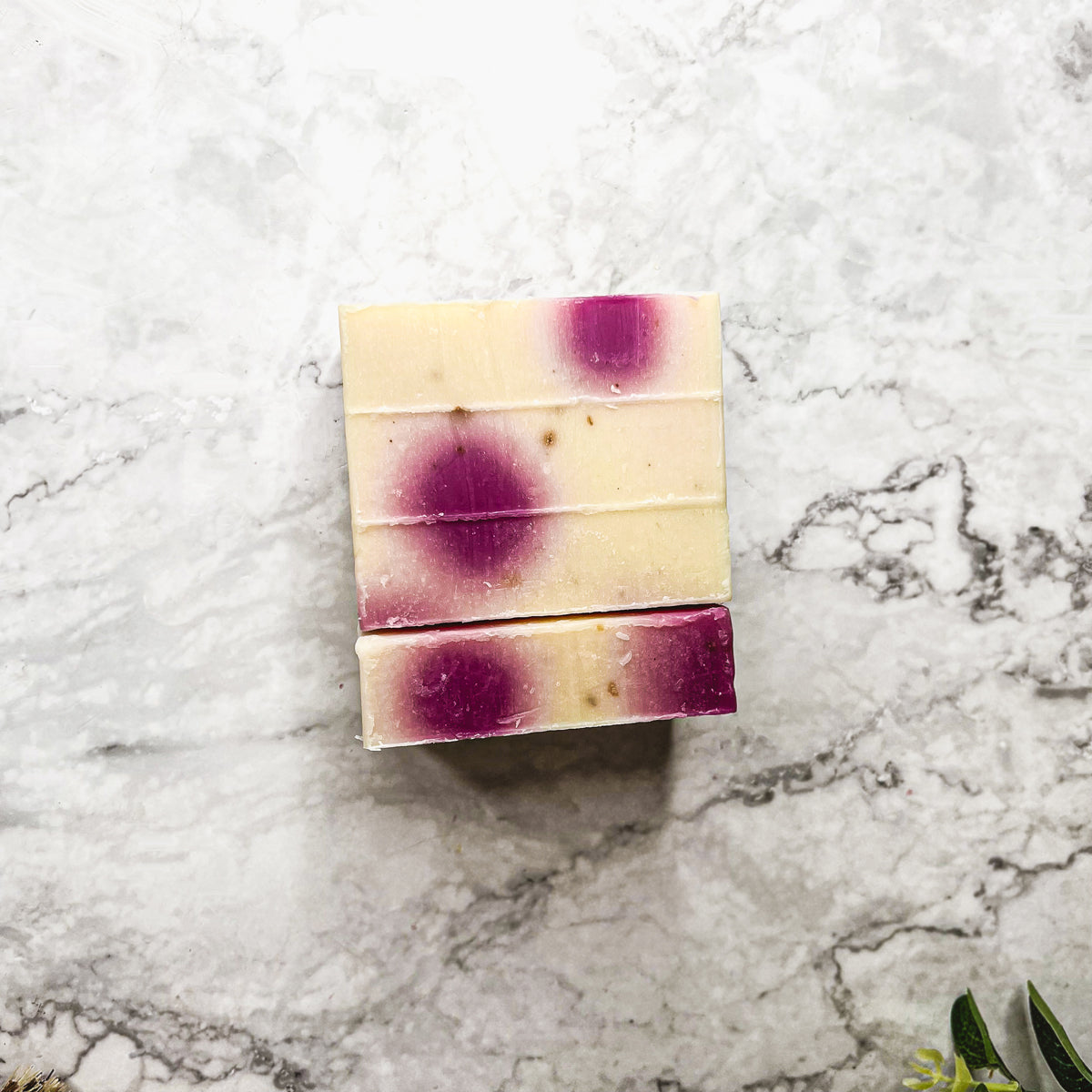 A beautifully handcrafted soap bar named Petal Dance, featuring real rose petals and a vibrant design, showcasing its organic ingredients.