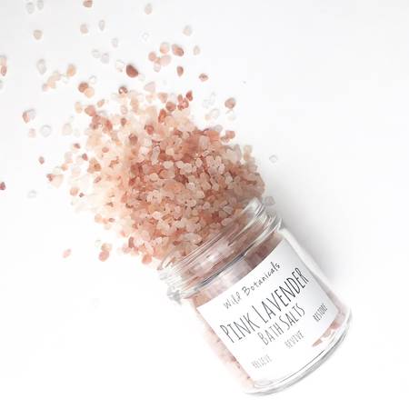 A jar of Pink Lavender Bath Salts with pink Himalayan salt and lavender flowers, showcasing its soothing properties.