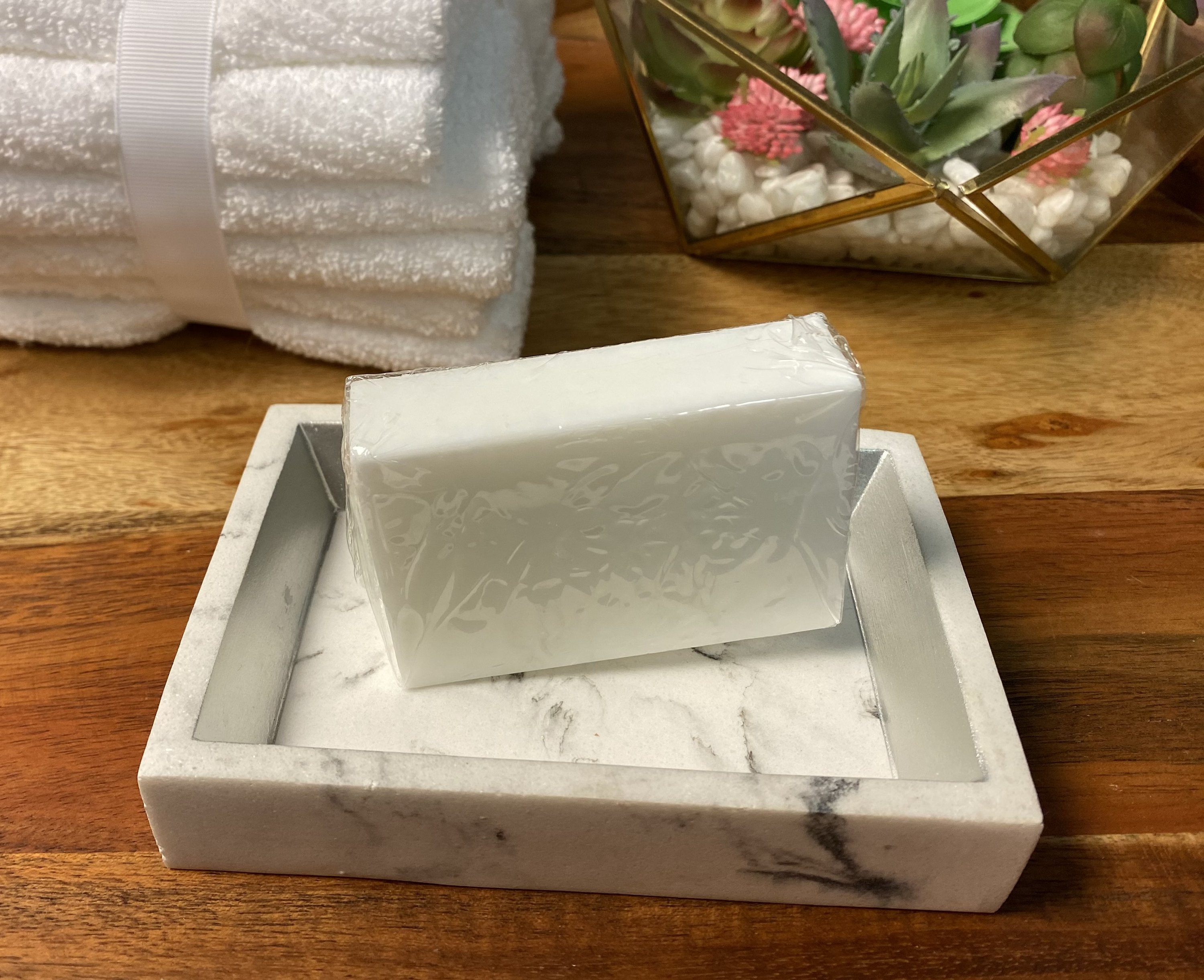 Plant Based Laundry & Dish Soap Bars made from 100% coconut oil, displayed on a wooden surface with a soap dish.