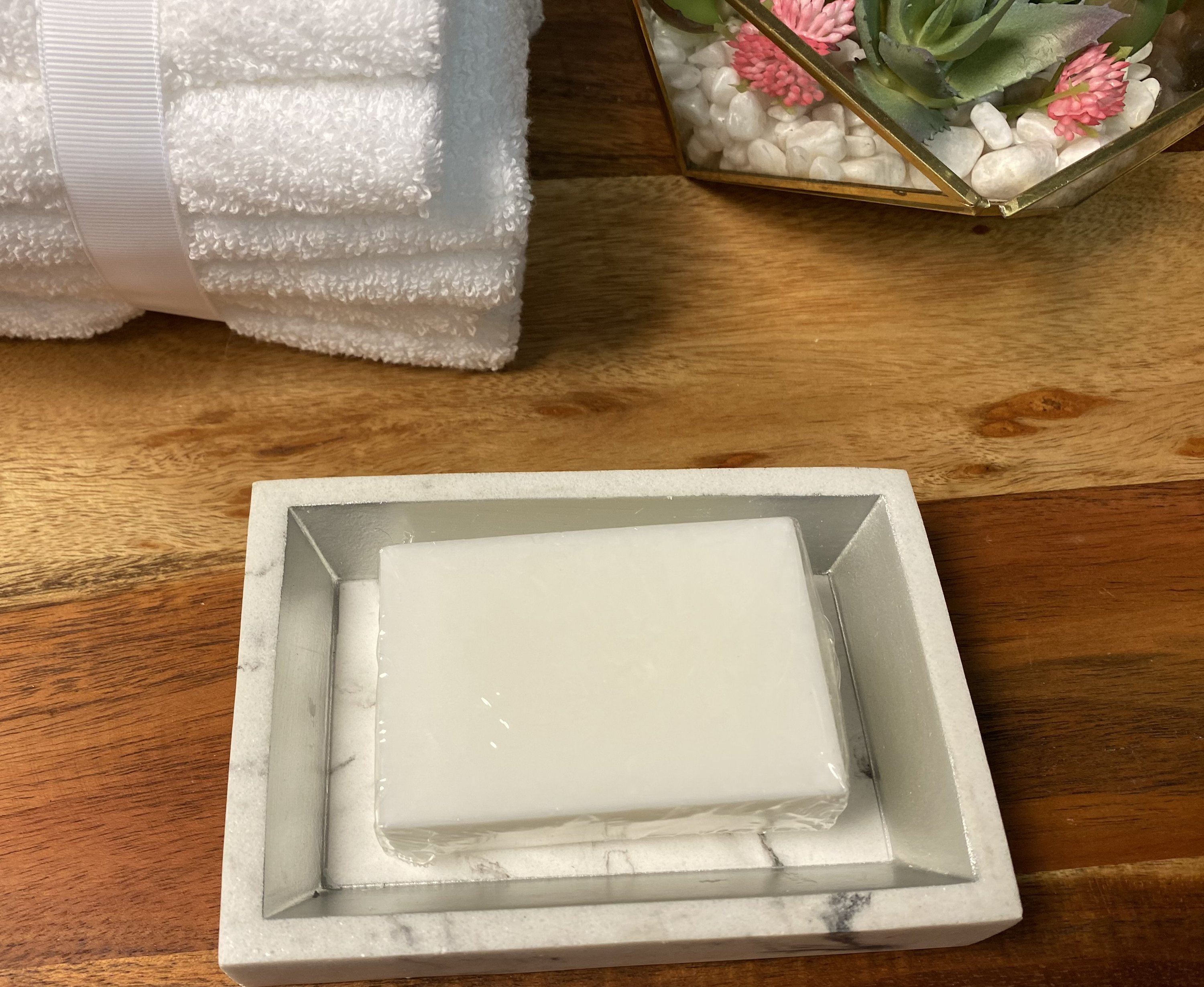 Plant Based Laundry & Dish Soap Bars made from 100% coconut oil, displayed on a wooden surface with a soap dish.