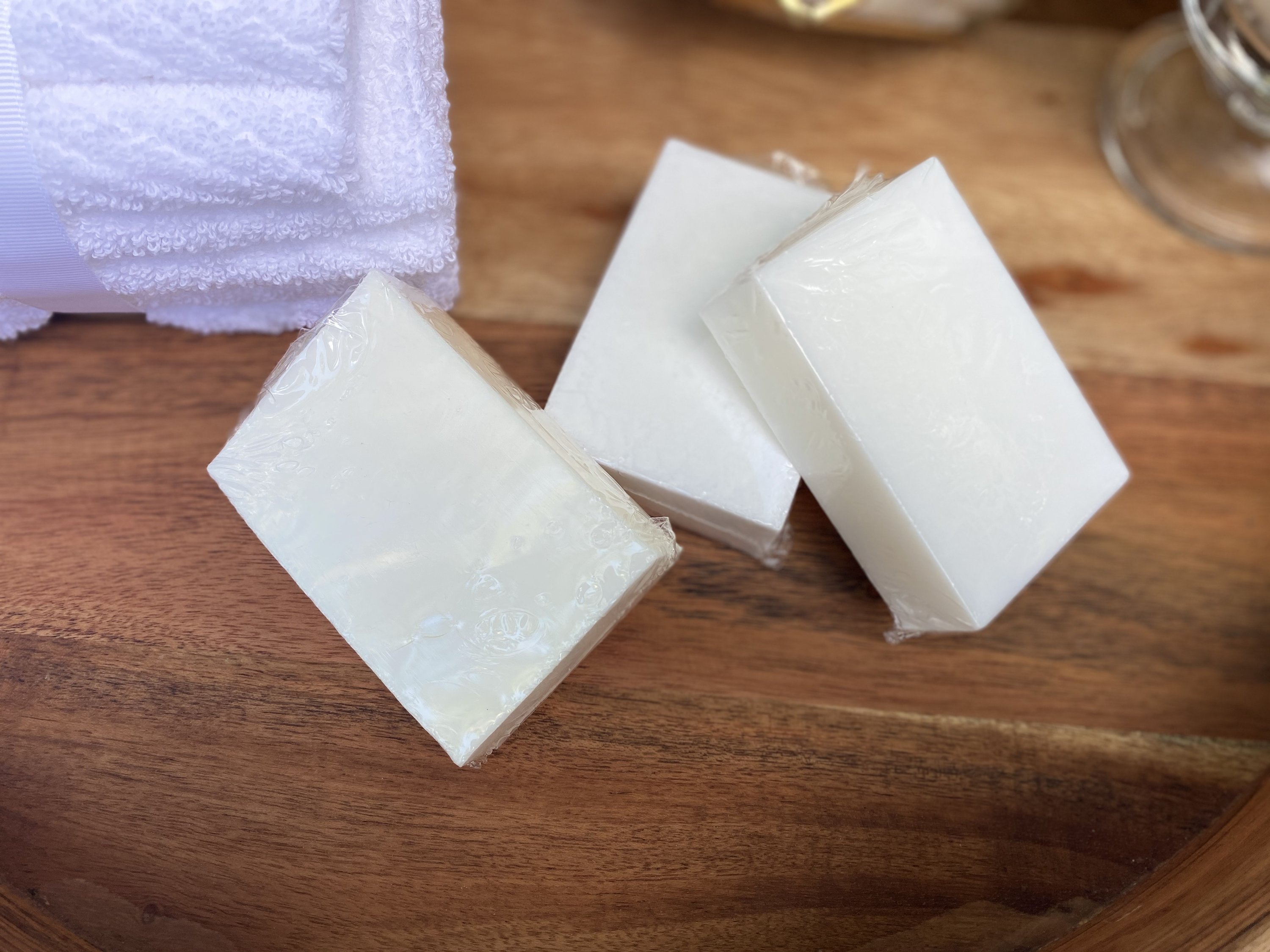 Plant Based Laundry & Dish Soap Bars made from 100% coconut oil, displayed on a wooden surface with a soap dish.