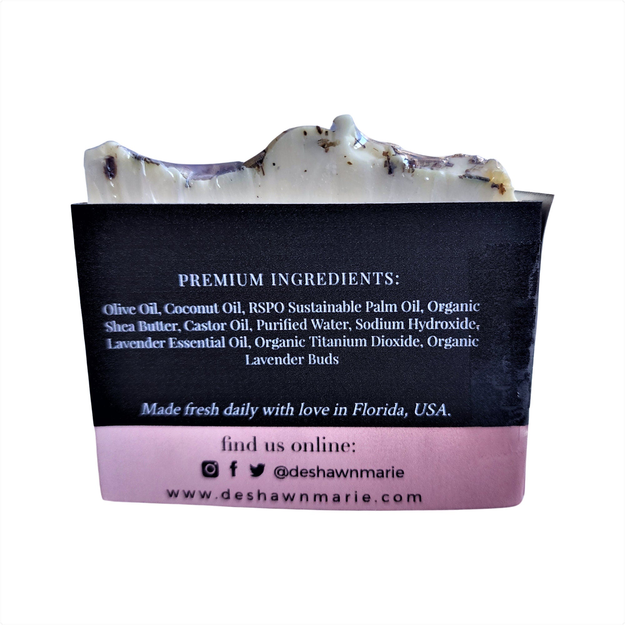 A beautifully crafted Pure Lavender Soap bar with lavender buds on top, showcasing its rich texture and vibrant color.