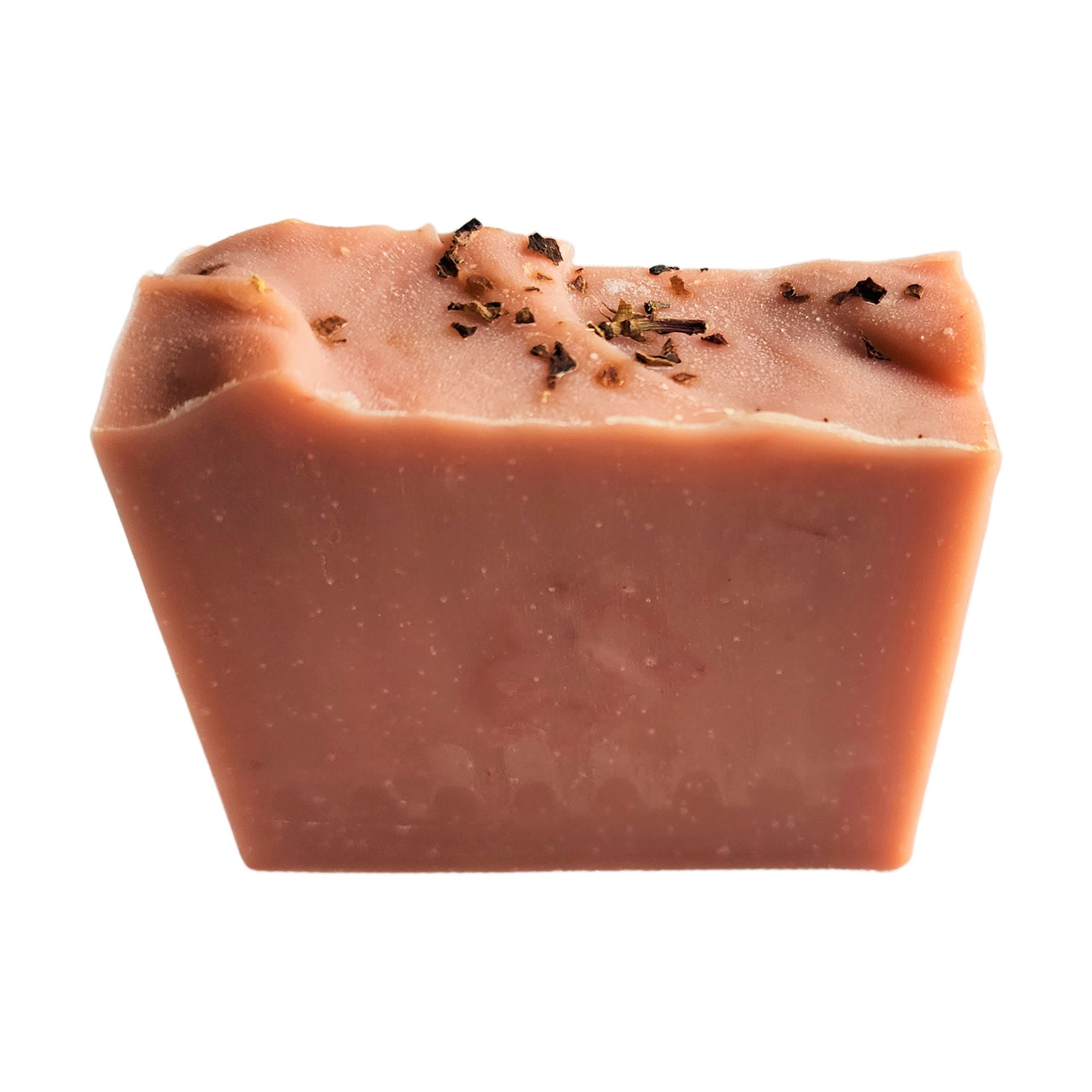 A beautifully crafted Rose Geranium Soap bar with pink clay and crushed rose petals, showcasing its delicate texture and vibrant color.