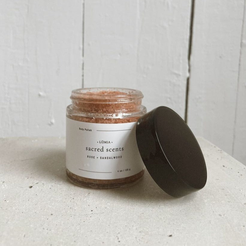 Sacred Scents Body Polish in a jar, showcasing pink Himalayan salt and essential oils, perfect for skin revitalization.