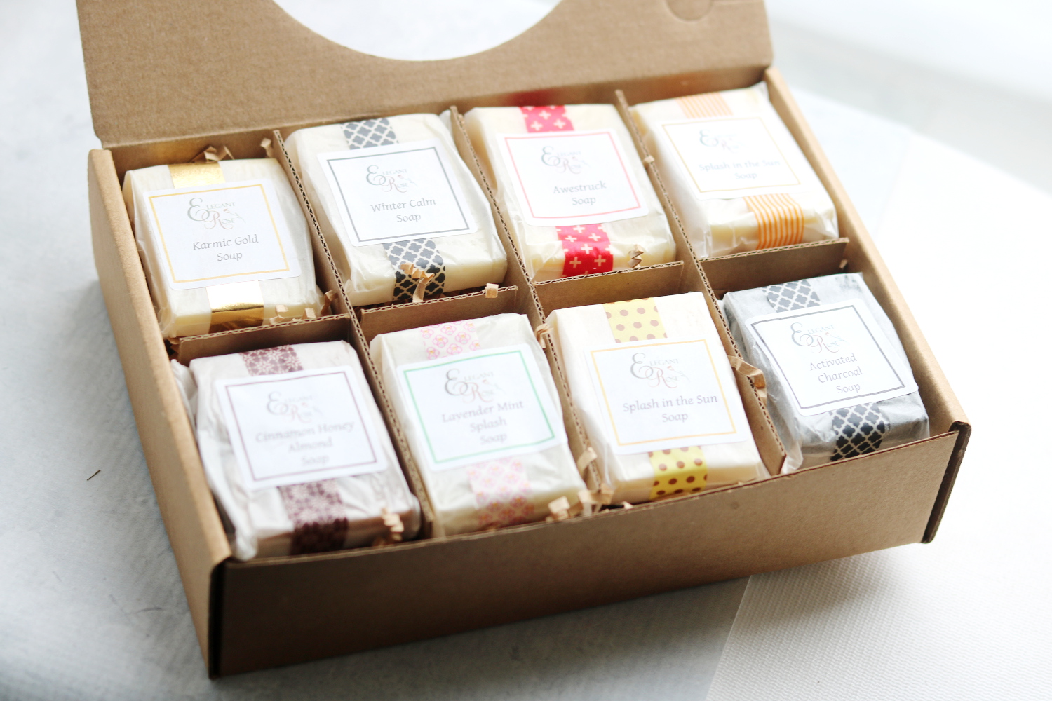 A beautifully arranged Soap Sampler Gift Set featuring eight natural soaps in various scents, tied with a decorative ribbon.