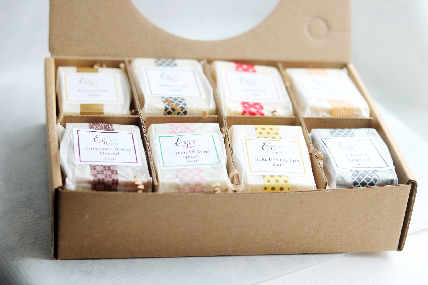 A beautifully arranged Soap Sampler Gift Set featuring eight natural soaps in various scents, tied with a decorative ribbon.