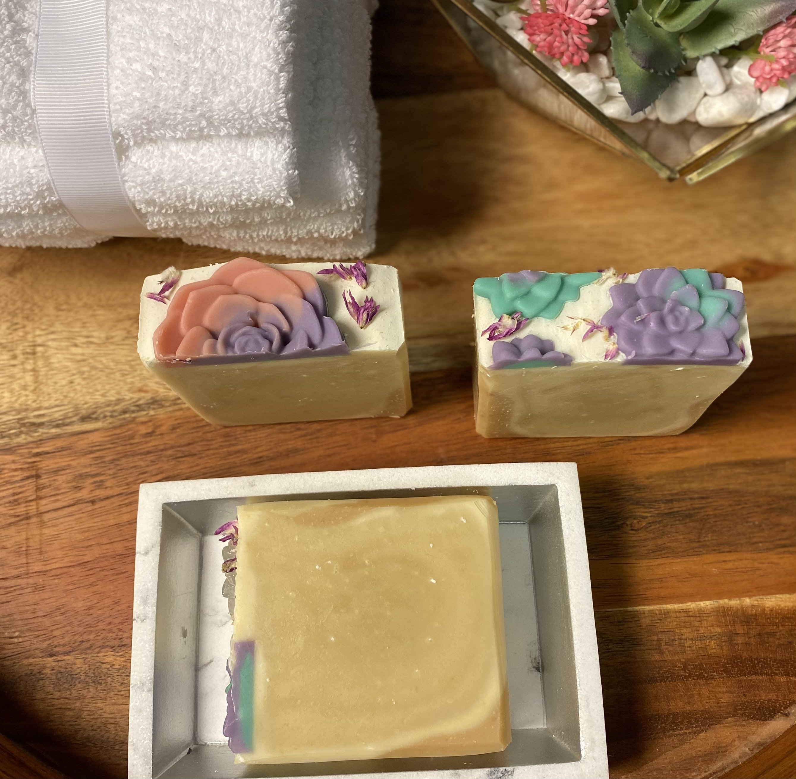 A bar of Soothing Goats Milk Peach Succulent Soap with a creamy texture and peach color, ideal for sensitive skin.