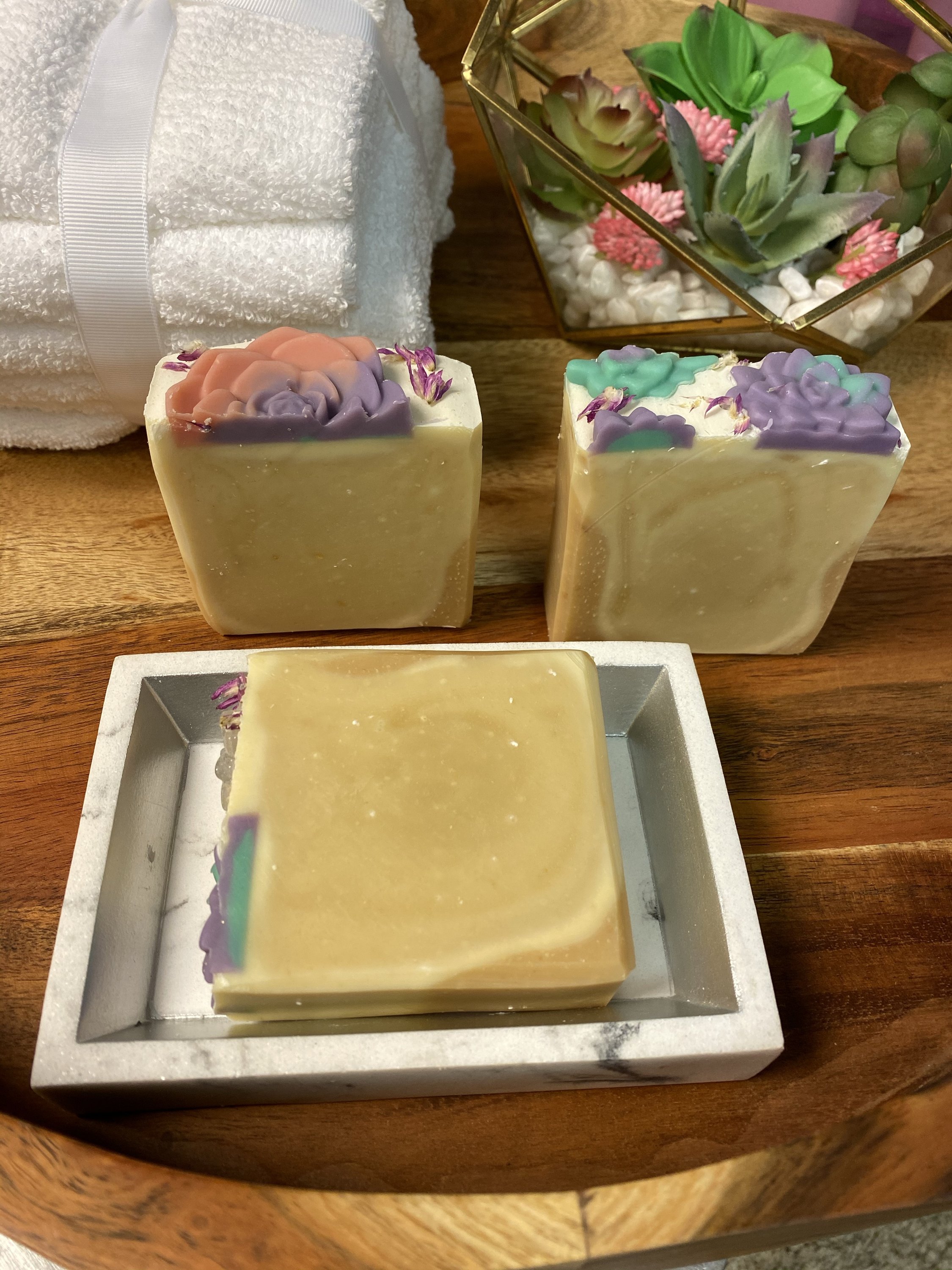 A bar of Soothing Goats Milk Peach Succulent Soap with a creamy texture and peach color, ideal for sensitive skin.