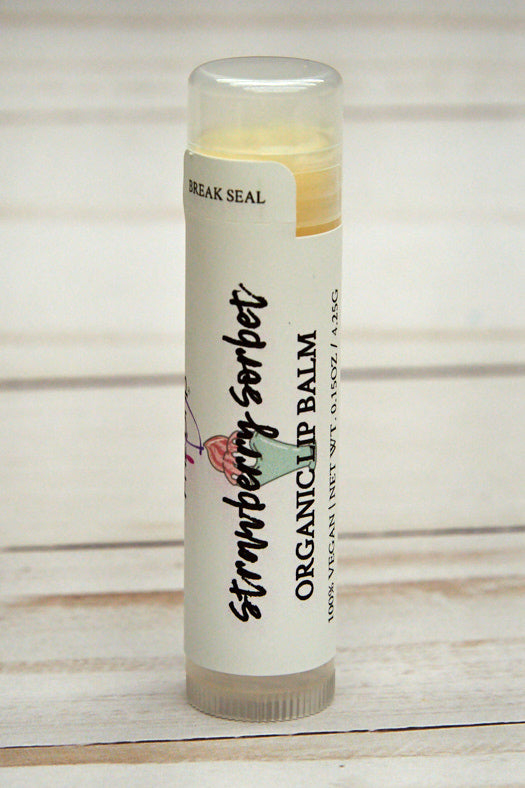 Strawberry Sorbet Lip Balm in a sleek tube, showcasing its vibrant packaging and creamy texture.