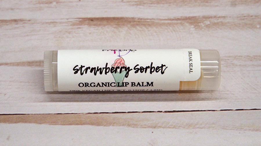 Strawberry Sorbet Lip Balm in a sleek tube, showcasing its vibrant packaging and creamy texture.