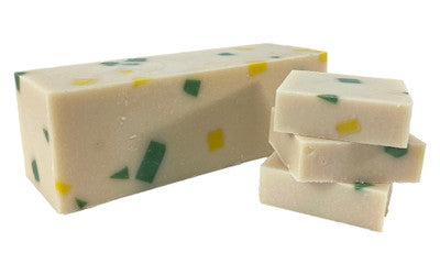 A vibrant bar of Summer Zest soap showcasing unique swirls and colors, made with natural oils and organic shea butter.