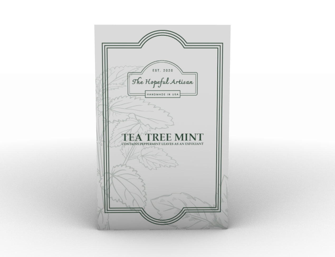 A bar of Tea Tree Mint soap with visible peppermint leaves, showcasing its natural ingredients and unique swirl patterns.